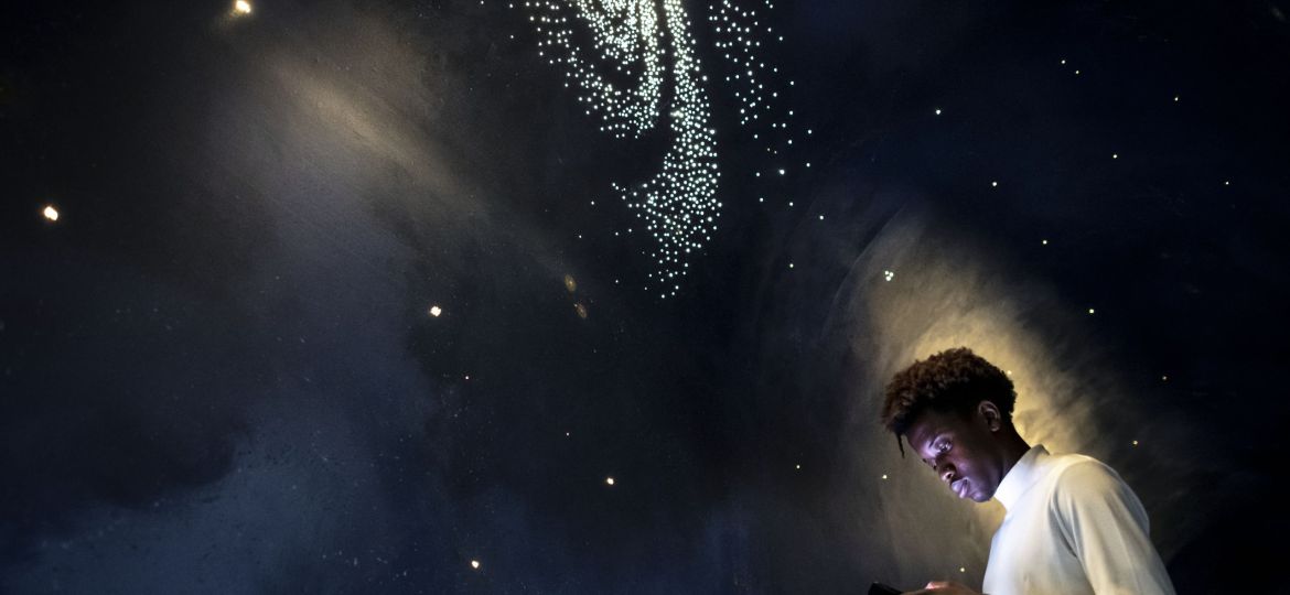 Man experiencing the universe at a planetarium