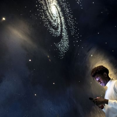 Man experiencing the universe at a planetarium